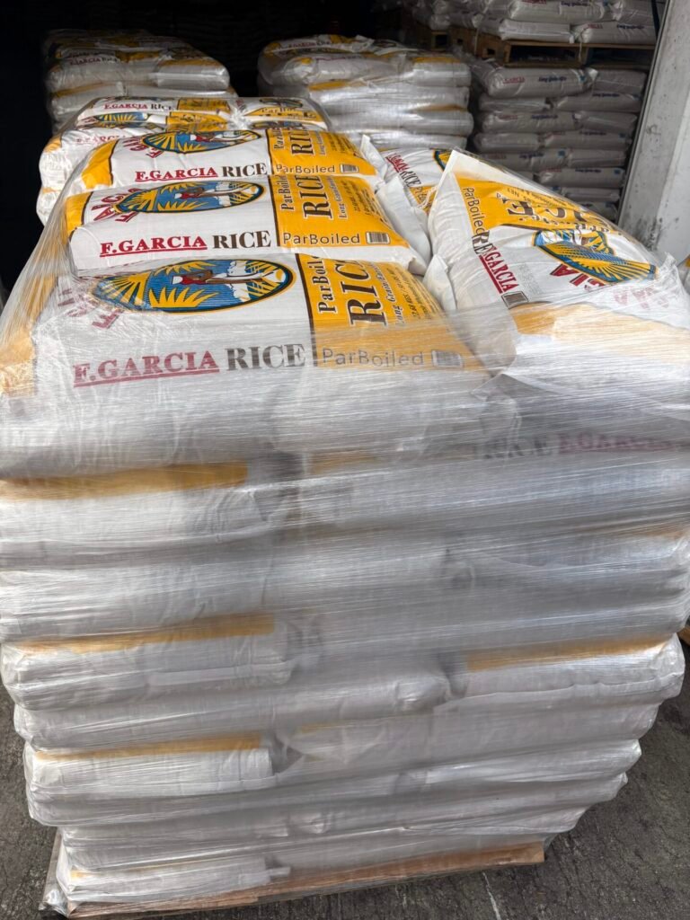 Pallets of F. Garcia parboiled long-grain rice bags stacked and shrink-wrapped in the warehouse, ready for shipment